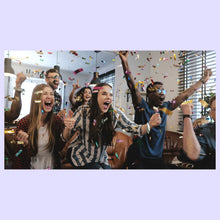 Load image into Gallery viewer, Group of people celebrating with confetti in an office setting.
