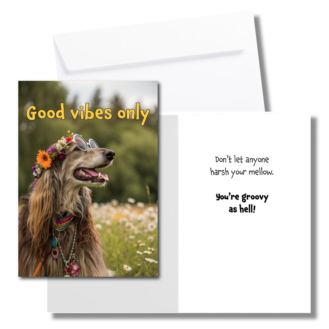 A greeting card with a hippie Irish setter sitting in a field of flowers, wearing a crown of flowers and round glasses. The front says, 
